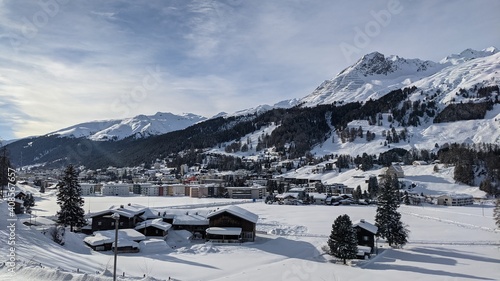 view into the valley of Davos Dorf including Parsenn with blue sky and plenty of snow