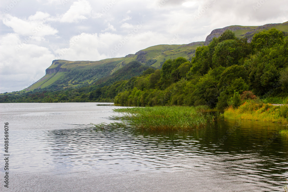 A view across Glencar Lough which lies in Counties Sligo and Leitrim in Ireland. Taken on a cloudy day with the Dartry Mountains in the background