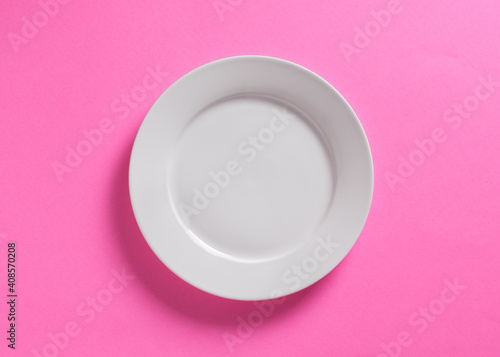 White dinner plate on pink