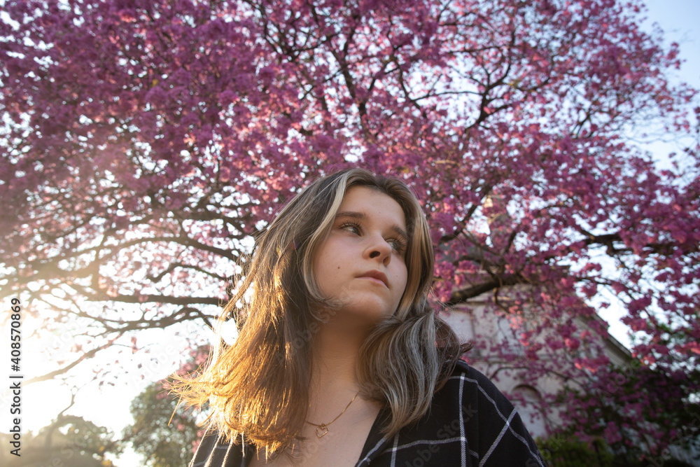 Portrait of a girl on the background of a pink flowering tree Portrait of a girl on the background of a pink flowering tree