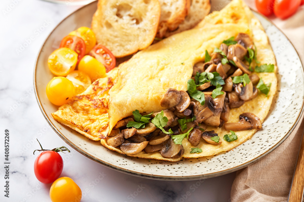 Omelet with champignons and parsley in plate on marble background. Frittata - italian omelet for breakfast or lunch.