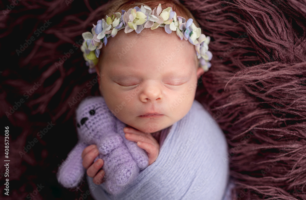 Newborn wearing diadem sleeping with toy Newborn wearing diadem sleeping with toy