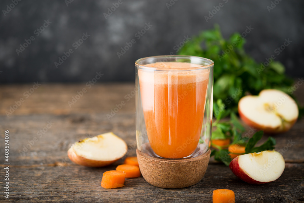 Fresh natural apple carrot juice in a glass glass, selective focus Fresh natural apple carrot juice in a glass glass, selective focus