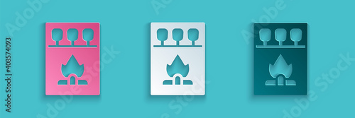 Paper cut Open matchbox and matches icon isolated on blue background. Paper art style. Vector.