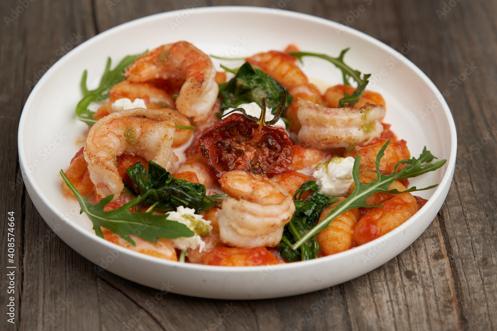 Gnocchi with shrimp and baked tomatoes. Italian seafood Gnocchi with shrimp and baked tomatoes. Italian seafood