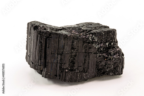 Extreme close-up of black tourmaline mineral isolated over white background