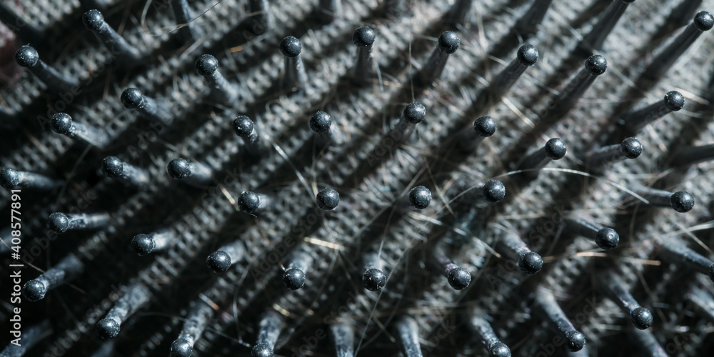 Macro image of dirty black hair brush surface overhead close view Macro image of dirty black hair brush surface overhead close view