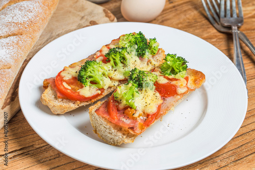 open sandwich with prosciutto mozzarella tomatoes kitchen table shallow focus (3)