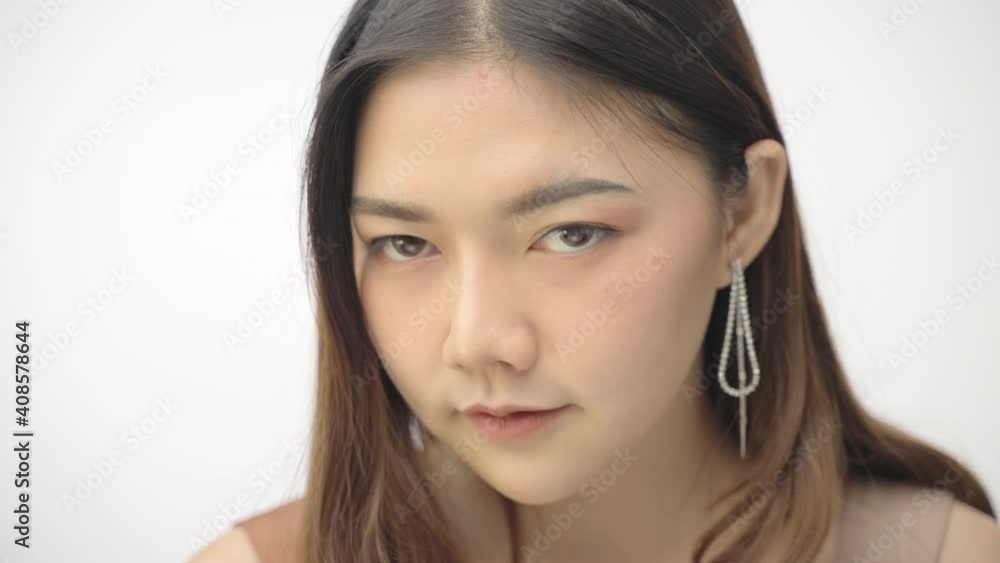 Close up of beautiful young happy woman with long hair smiling at camera with white background Close up of beautiful young happy woman with long hair smiling at camera with white background