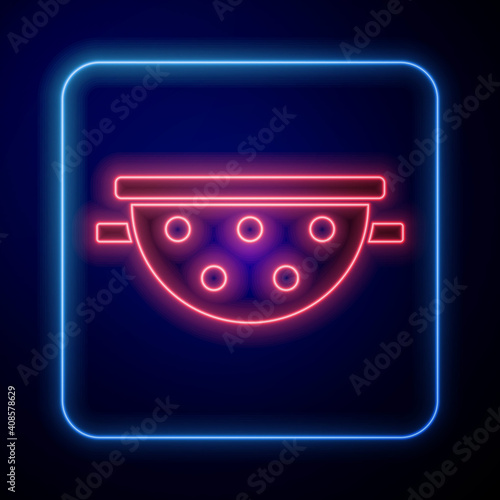 Glowing neon Kitchen colander icon isolated on blue background. Cooking utensil. Cutlery sign. Vector.