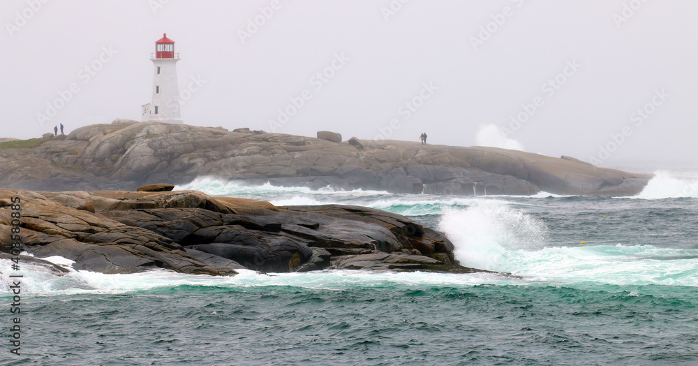 The iconic Peggy's Cove Lighthouse located in Nova Scotia has withstood many storms and crashing waves on the granite rocks that it stands on.