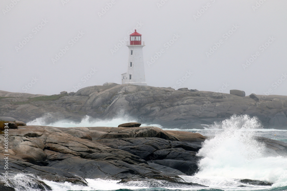The iconic Peggy's Cove Lighthouse located in Nova Scotia has withstood many storms and crashing waves on the granite rocks that it stands on.