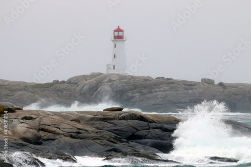 The iconic Peggy's Cove Lighthouse located in Nova Scotia has withstood many storms and crashing waves on the granite rocks that it stands on.