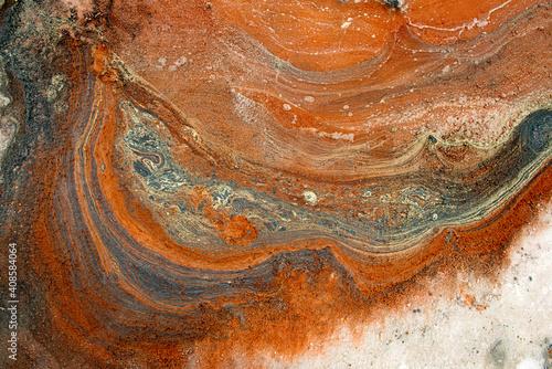 Amazing panoramic aerial landscape of beautiful salt plains. Salt lake. Bright red and orange salt deposits in artificial salt evaporators, salt mining. Top view.