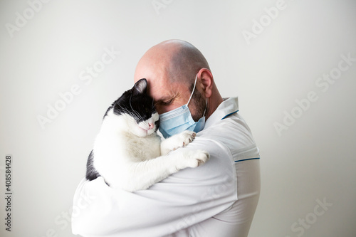 veterinarian hugs a cat in his arms. veterinary medicine. pet care