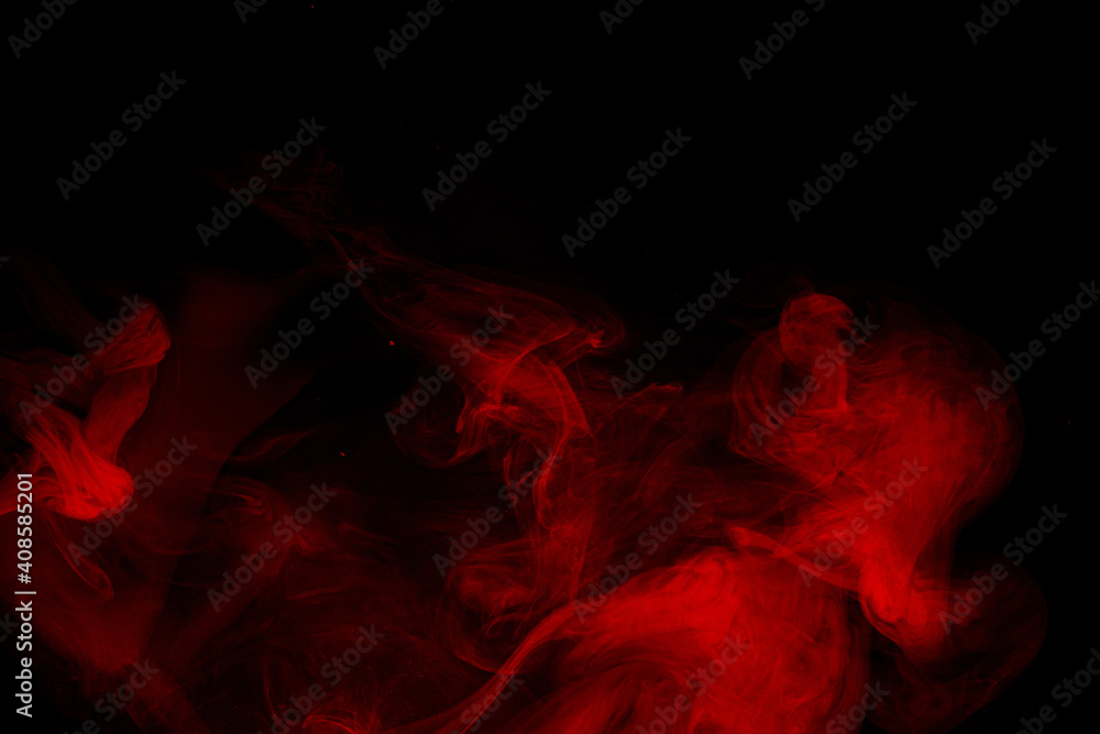 Abstract red smoke moves on black background. Beautiful swirling smoke.