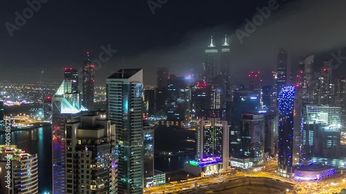 Wallpaper Mural Aerial view of a big modern city at night timelapse with night traffic and illuminated skyscrapers, office buildings. Business bay, Dubai, United Arab Emirates. Torontodigital.ca