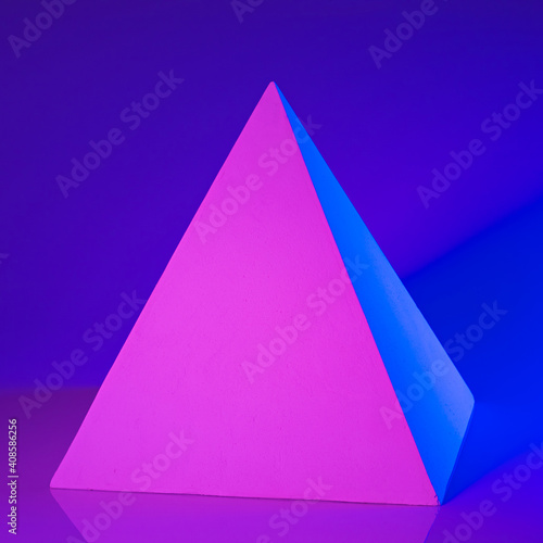 Gypsum pyramid in pink and blue neon light