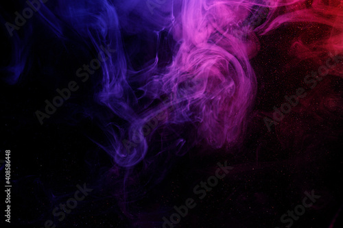 Abstract purple smoke moves on black background. Beautiful swirling smoke.