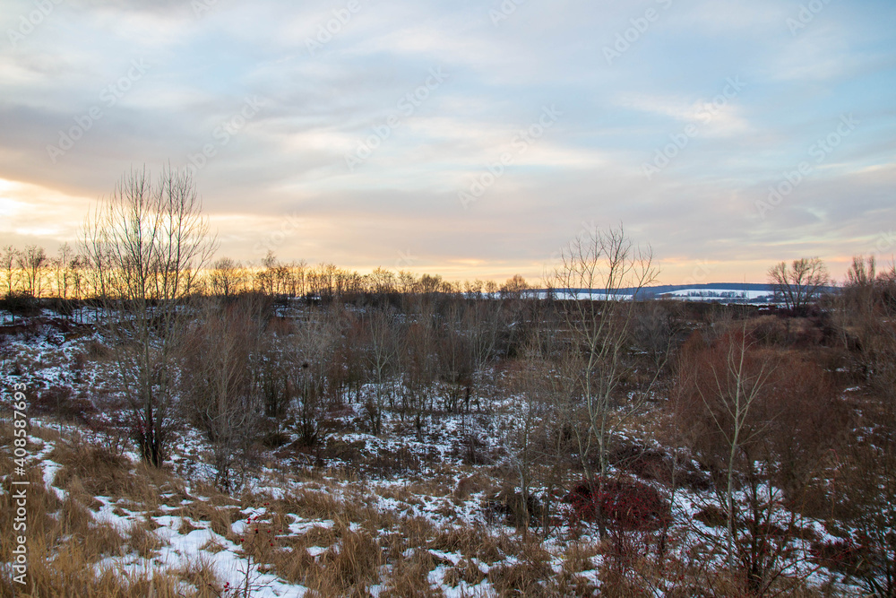 Snowy valley landscape with a sunset over the fields Snowy valley landscape with a sunset over the fields