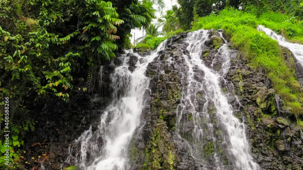Beautiful waterfall in the rainforest. Mimbalut Falls Waterfall in the tropical mountain jungle. Philippines, Mindanao. Iligan City, Lanao del Norte. Beautiful waterfall in the rainforest. Mimbalut Falls Waterfall in the tropical mountain jungle. Philippines, Mindanao. Iligan City, Lanao del Norte.