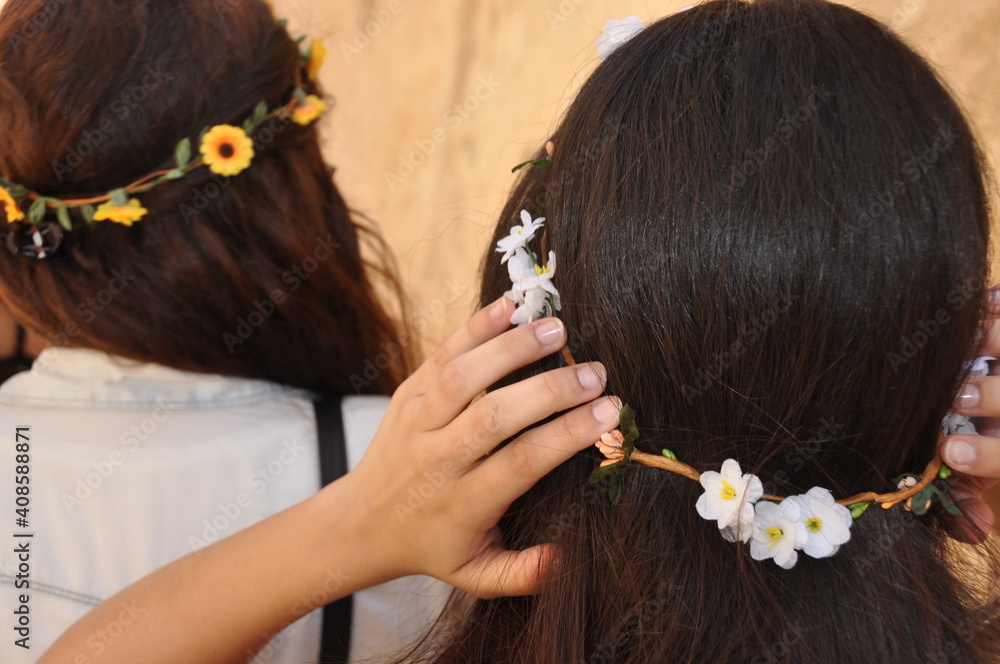 Brunette girl with a flower crown on the head.