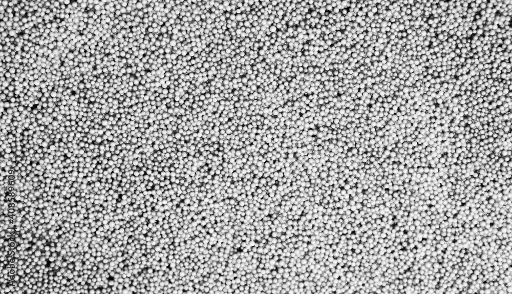 Black and white slime texture with small foam balls. Abstract background of educational children's toys