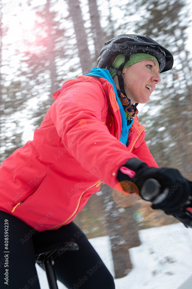 Attractive woman rides her fat bike in the snow