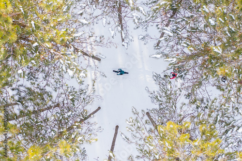 Obraz na płótnie Aerial photo of a couple riding fat bikes in the snow w salonie
