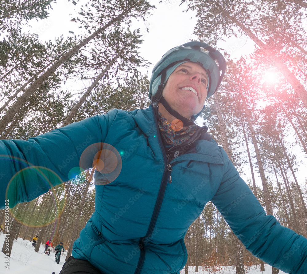 Attractive woman rides her fat bike in the snow
