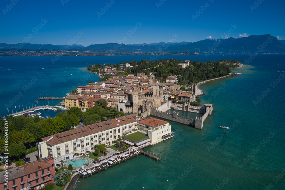 Archaeological site of Grotte di Catullo. Sirmione island aerial view. Garda lake, Sirmione, Italy. Aerial view on Grotte di Catullo. Sun reflections in water