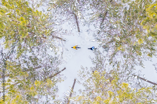 Aerial photo of a couple riding fat bikes in the snow