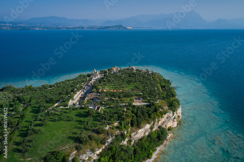 Fototapeta Naklejka Na Ścianę i Meble -  Archaeological site of Grotte di Catullo, Sirmione, Italy early morning aerial view. lake garda. Grottoes of Catullus is the name given to the ruins of a Roman villa