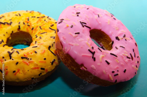 Colorful glazed donuts on a blue background