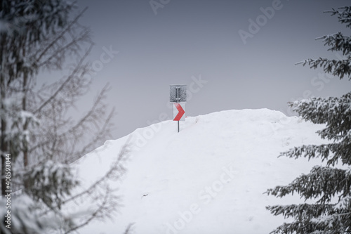 Traffic sign turn in winter landscape on top of the mountains