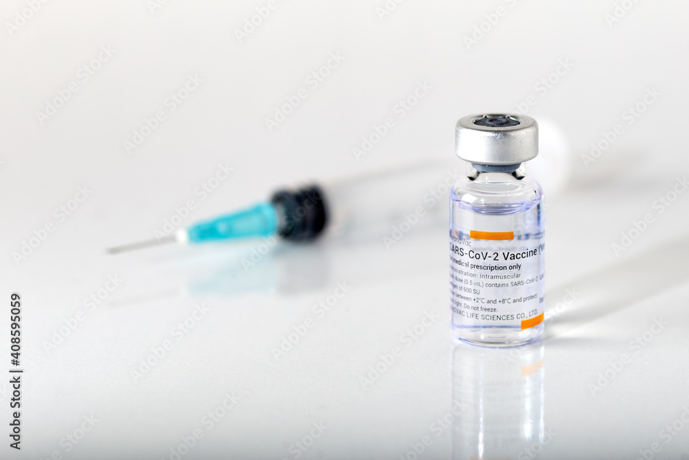 Izmir, Turkey - 01-26-2021: Sinovac Covid -19 vaccine vial and injection syringe isolated on white background. Izmir, Turkey - 01-26-2021: Sinovac Covid -19 vaccine vial and injection syringe isolated on white background.