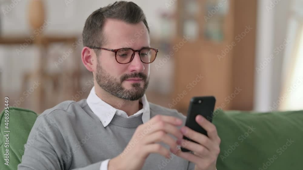 Portrait of Middle Aged Man using Smartphone on Sofa Portrait of Middle Aged Man using Smartphone on Sofa
