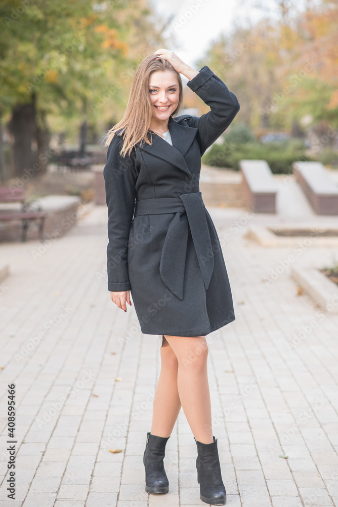 Beautiful and cute blonde girl with pleasure posing on the street Beautiful and cute blonde girl with pleasure posing on the street