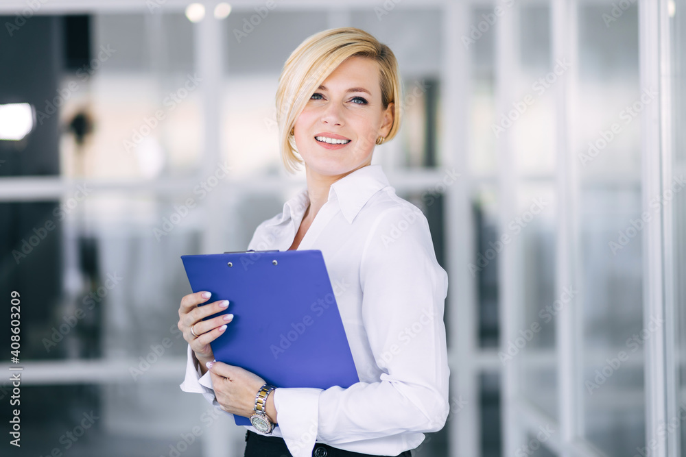 Smiling beautiful business woman holding open folder with docume Smiling beautiful business woman holding open folder with docume