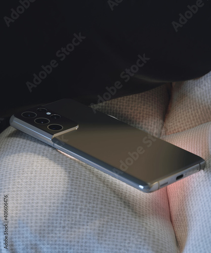 Close-up of a smartphone placed in the armchair.