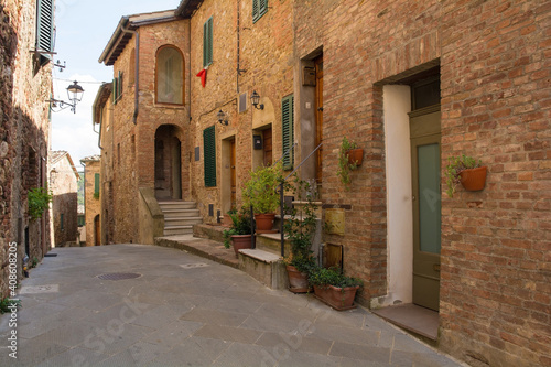 A quiet residential street in the historic centre of the medieval town of Monticiano in Siena Province, Tuscany, Italy 