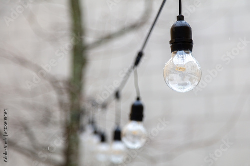 illumination on the street, electric bulbs on the wire. Lighting concept