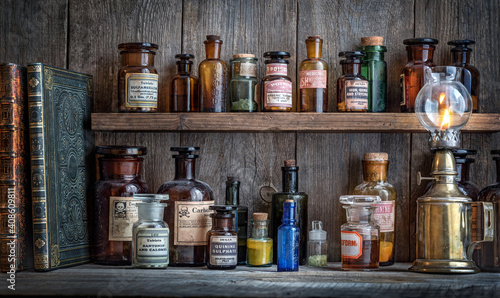 Bottles with drugs from old medical, chemical and pharmaceutical glass. Chemistry and pharmacy history concept background. Retro style. Chemical substances.