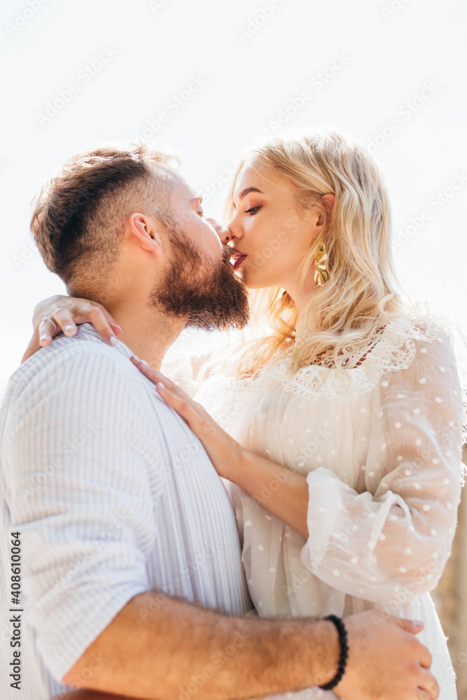 Loving and happy couple kissing outdoors in summer Loving and happy couple kissing outdoors in summer