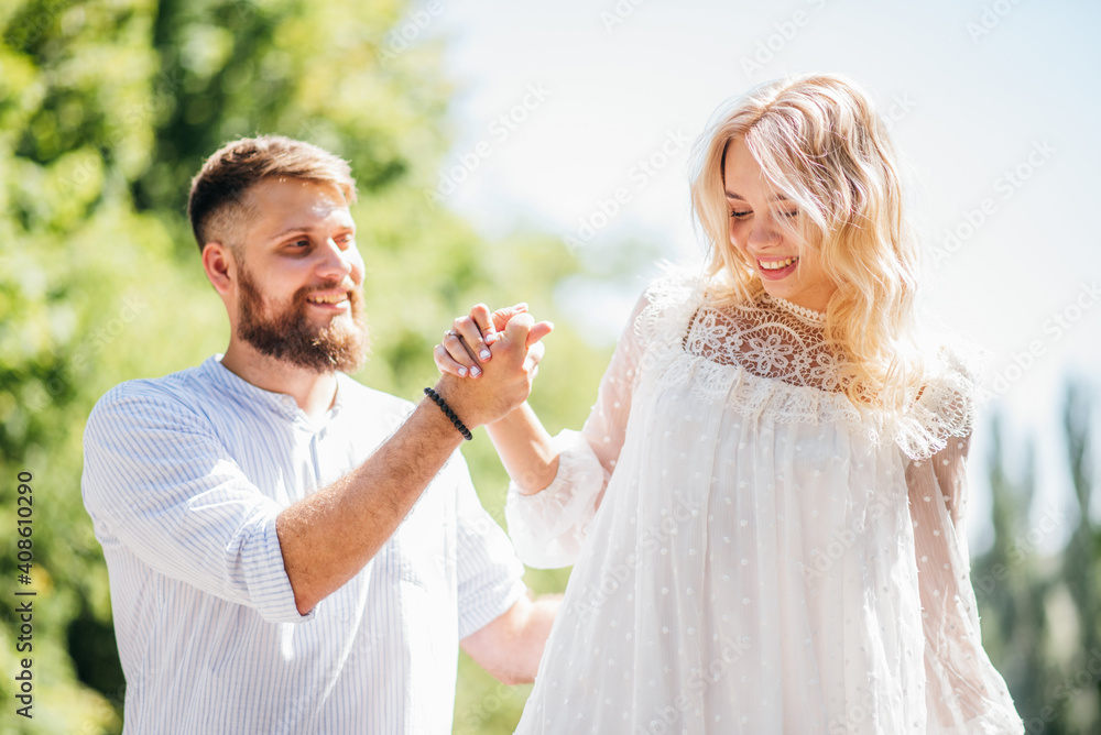 Couple in love and laughing holding hands walking on the road in summer Couple in love and laughing holding hands walking on the road in summer