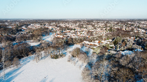 Snow covered town and rooftops in United Kingdom from aerial drone
