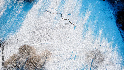 Snow covered public park birds eye view, aerial drone