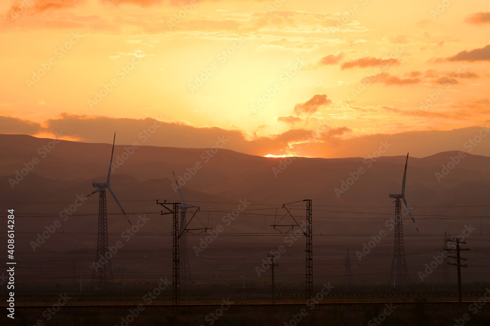 Obraz premium Wind generators at sunset.