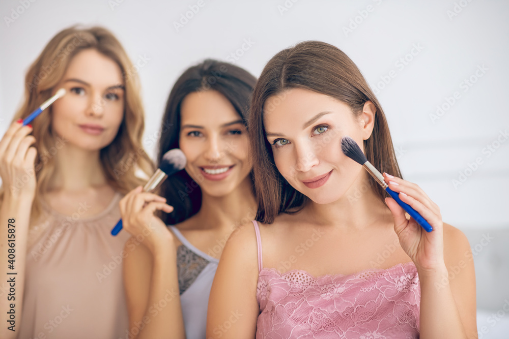 Pretty girls doing make up and looking happy Pretty girls doing make up and looking happy