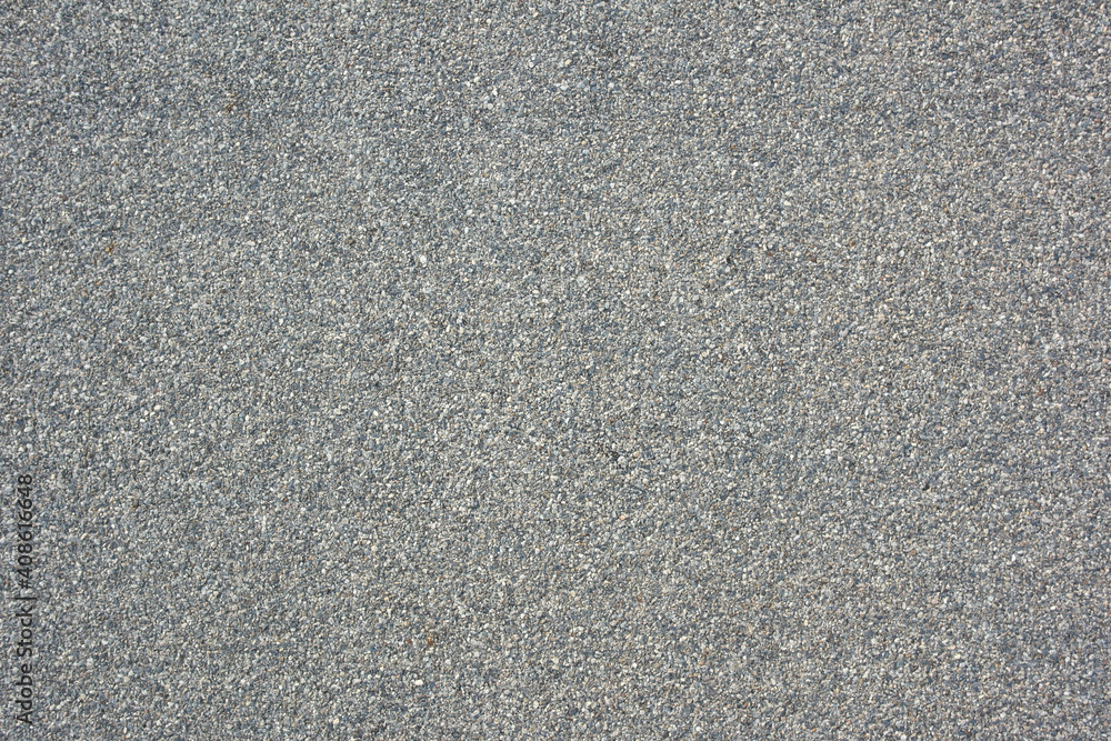 A textured background with small patches of gray in various shades. A textured background with small patches of gray in various shades.